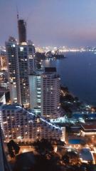 High-rise residential buildings with a view of the coastal cityscape at dusk