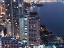 High-rise residential buildings with a view of the coastal cityscape at dusk