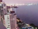 Aerial view of high-rise buildings along a coastal area during twilight