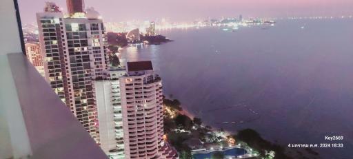 Aerial view of high-rise buildings along a coastal area during twilight