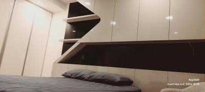 Modern bedroom with sleek built-in shelves and mood lighting