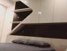 Modern bedroom with sleek built-in shelves and mood lighting