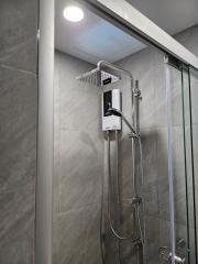 Modern bathroom with walk-in shower and wall-mounted water heater