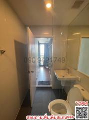 Bright bathroom with open door leading to hallway