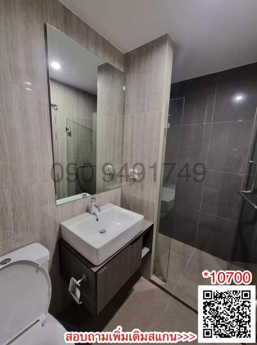 Compact modern bathroom interior with glass shower door