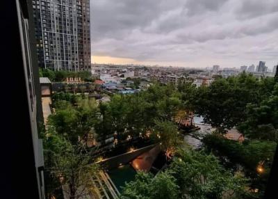 High-rise balcony view overlooking city and greenery