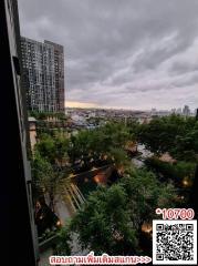 High-rise balcony view overlooking city and greenery