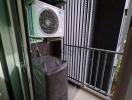 Compact balcony with air conditioning units and protective cover