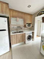 Modern kitchen with wooden cabinets and stainless steel appliances