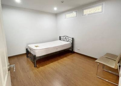 Spacious bedroom with hardwood floors and minimalistic design