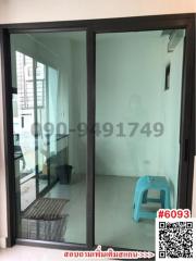 Small balcony area with glass door and white walls in a residence