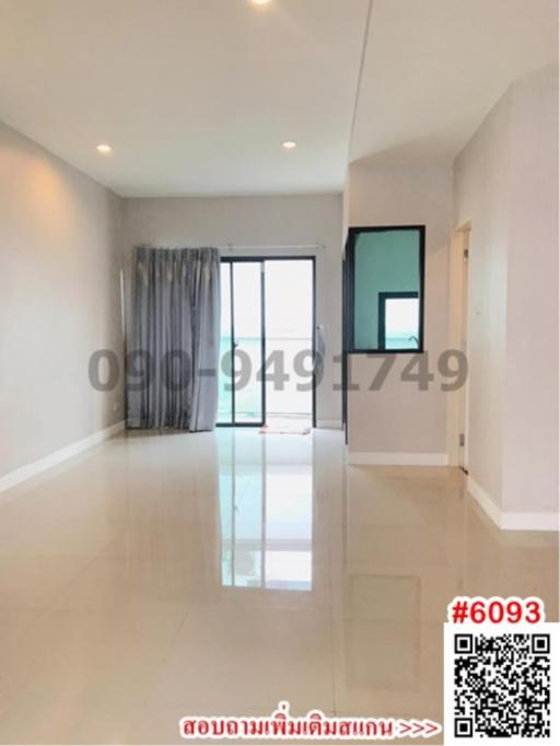 Spacious and well-lit empty room with large windows and glossy tiled flooring