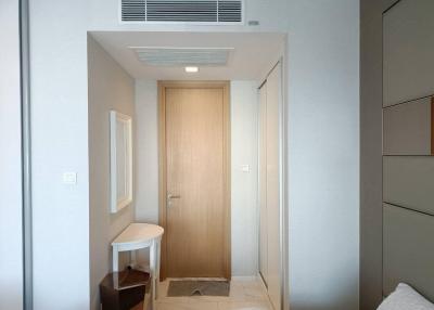 Modern entrance of an apartment with a wooden door and minimalist design