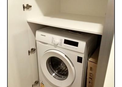 Compact built-in laundry space with modern washing machine