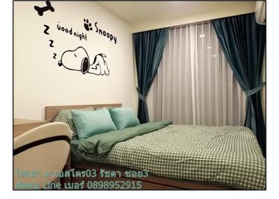 Cozy bedroom with Snoopy wall decoration and blue curtains
