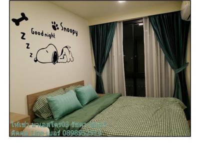 Cozy bedroom with Snoopy wall decor and teal accents