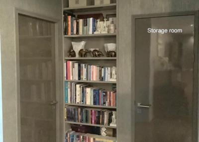 Hallway with bookshelf and storage room door