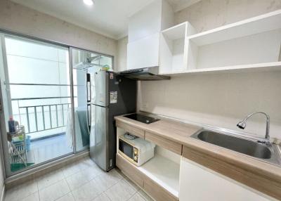 Modern kitchen with stainless steel appliances and balcony access