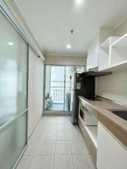 Compact kitchen with modern appliances and balcony access