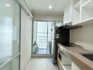 Compact kitchen with modern appliances and balcony access