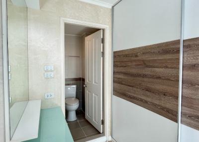 Bright bathroom with mirrored wardrobe doors and tiled flooring