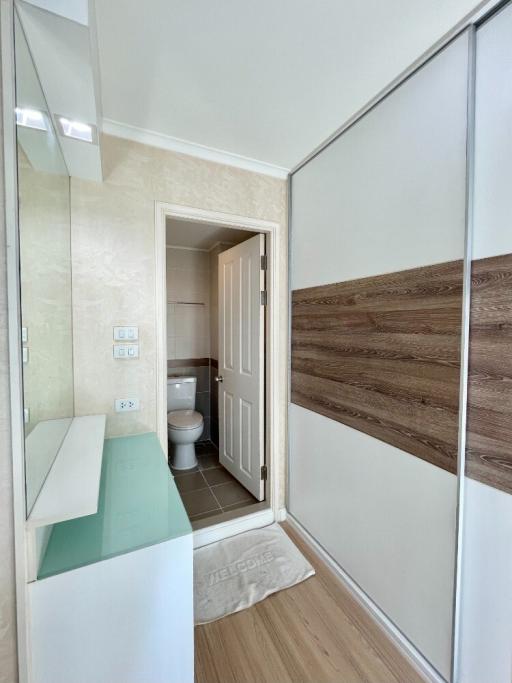 Bright bathroom with mirrored wardrobe doors and tiled flooring