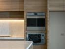 Modern kitchen interior with built-in appliances and marble backsplash