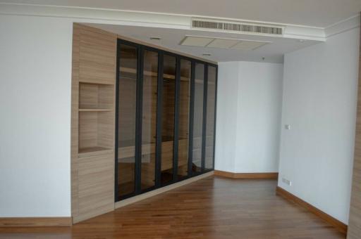 Spacious living room with wooden flooring and large glass doors