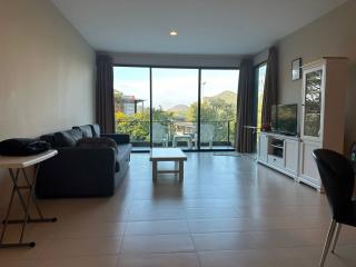 Spacious living room with natural light and balcony access