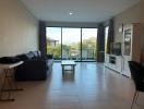 Spacious living room with natural light and balcony access