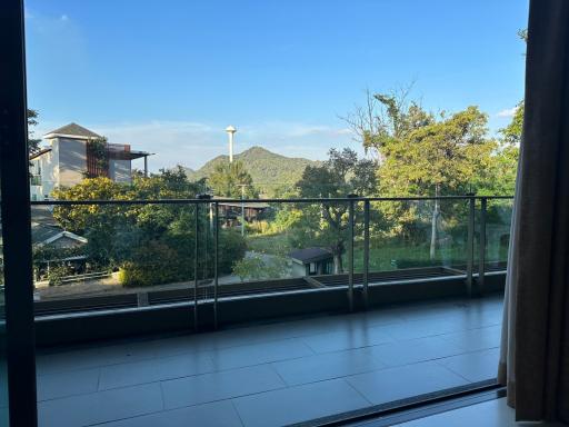 Spacious balcony with a scenic view of the mountains and greenery