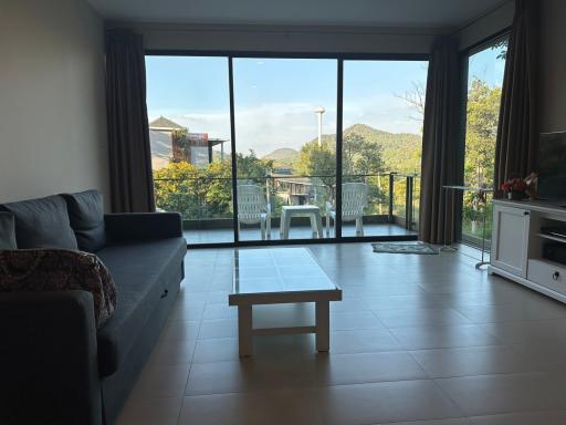 Spacious living room with large windows and balcony access