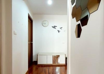 Bright corridor with wooden flooring and modern wall decoration