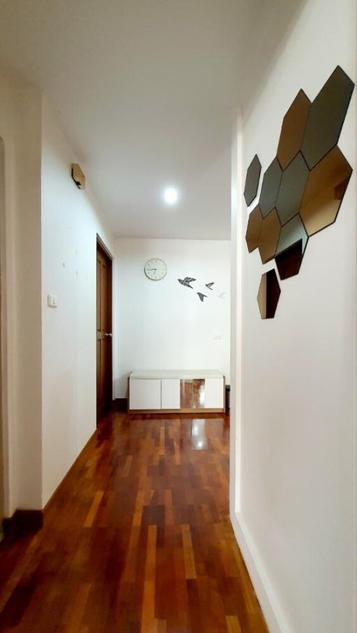 Bright corridor with wooden flooring and modern wall decoration