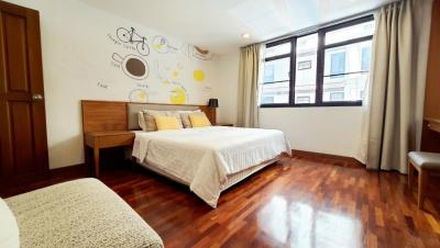 Bright and cozy bedroom with artistic wall decor and hardwood flooring