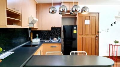 Modern kitchen with stainless steel appliances and wooden cabinets