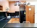 Modern kitchen with stainless steel appliances and wooden cabinets