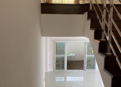 Interior view of a building showcasing the staircase and entrance area