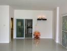 Spacious living room with tiled flooring, natural light, and modern decor