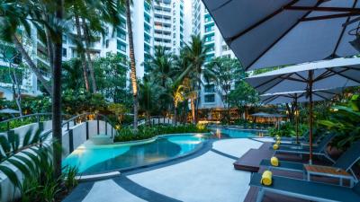 Luxurious apartment complex pool with garden and lounging areas