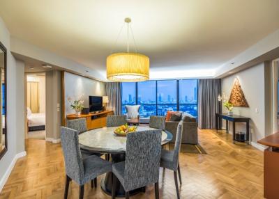 Spacious and well-lit living area with city skyline view