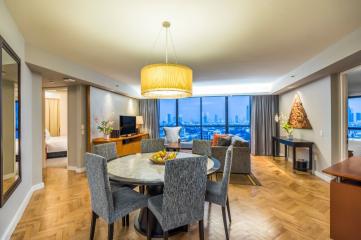 Spacious and well-lit living area with city skyline view