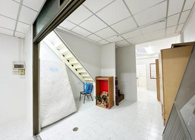 Spacious hallway with staircase and storage area