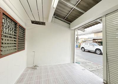Spacious garage with white walls and tiled floor