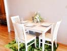 Cozy dining area with a white table and chairs set on a vibrant green rug