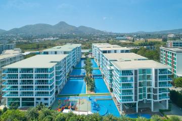 Aerial view of a resort-style apartment complex with swimming pools