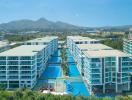 Aerial view of a resort-style apartment complex with swimming pools