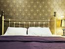 Elegant bedroom with decorative wallpaper and vintage bedside lamp