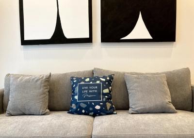 Cozy living room with modern grey sofa and decorative pillows