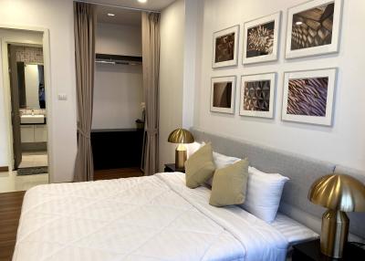 Elegant bedroom with en-suite bathroom and curated artwork